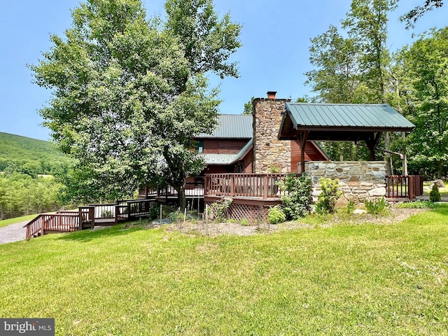 299 Valentine Acres Rd, Clearville, PA 15535 - back of house featuring a wooden deck, a chimney, a lawn, metal roof, and stone siding