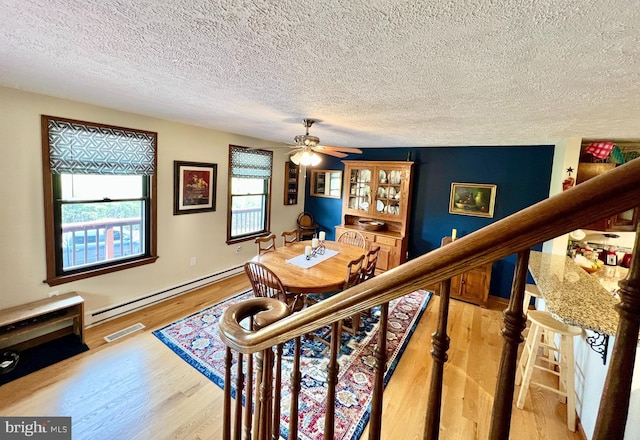 299 Valentine Acres Rd, Clearville, PA 15535 - office space with baseboard heating, a textured ceiling, wood finished floors, and ceiling fan
