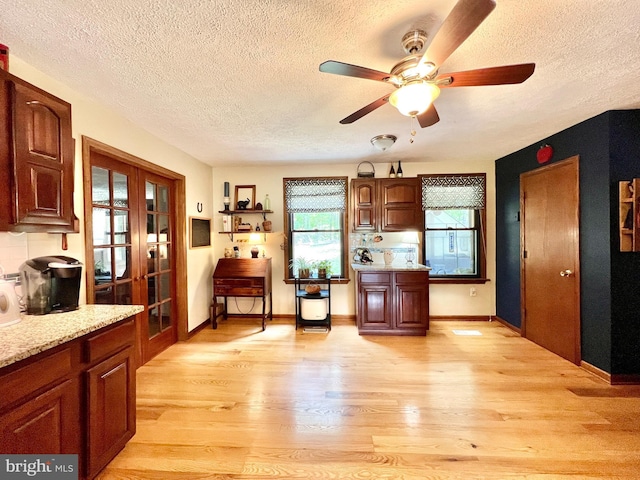 299 Valentine Acres Rd, Clearville, PA 15535 - kitchen featuring light wood-style floors, a textured ceiling, a ceiling fan, baseboards, and french doors