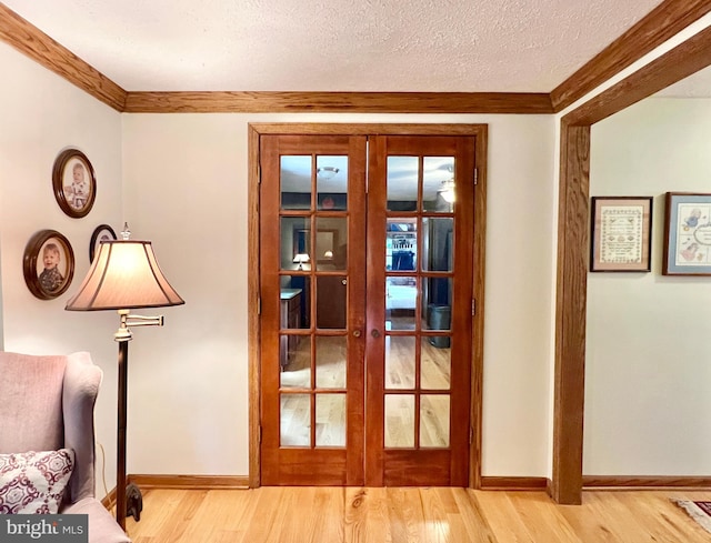 299 Valentine Acres Rd, Clearville, PA 15535 - entryway with french doors, light wood finished floors, baseboards, crown molding, and a textured ceiling