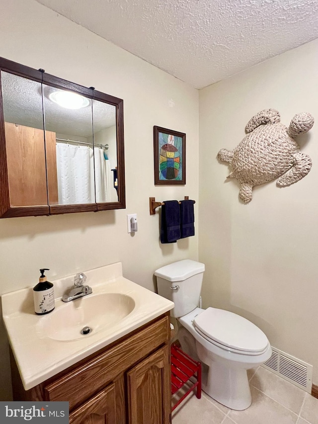 299 Valentine Acres Rd, Clearville, PA 15535 - bathroom with vanity, toilet, tile patterned floors, and a textured ceiling