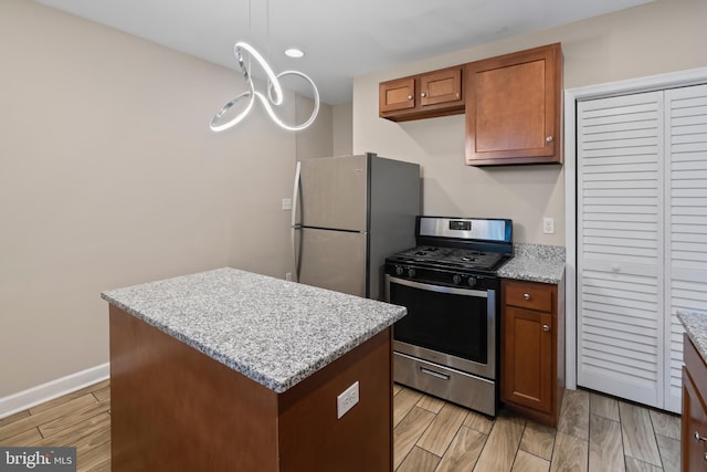 1619 Moreland Ave, Baltimore, MD 21216 - kitchen with stainless steel appliances, a kitchen island, brown cabinetry, and light wood finished floors
