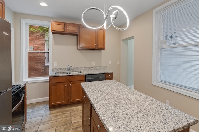 1619 Moreland Ave, Baltimore, MD 21216 - kitchen with appliances with stainless steel finishes, a sink, brown cabinetry, and light stone countertops