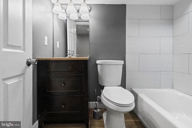 1619 Moreland Ave, Baltimore, MD 21216 - full bathroom with toilet, a tub to relax in, vanity, baseboards, and wood finished floors