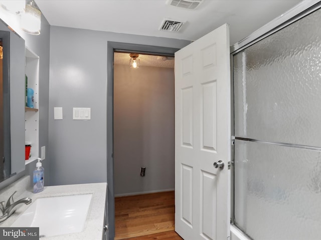 11815 Oriole Dr, Hagerstown, MD 21742 - full bath with wood finished floors, a shower stall, vanity, and baseboards
