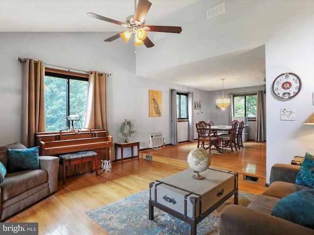 11815 Oriole Dr, Hagerstown, MD 21742 - living room with light wood-type flooring, ceiling fan, high vaulted ceiling, and a chandelier