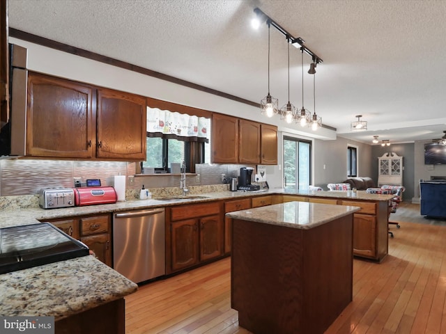 11815 Oriole Dr, Hagerstown, MD 21742 - kitchen featuring dishwasher, a sink, a peninsula, open floor plan, and a textured ceiling