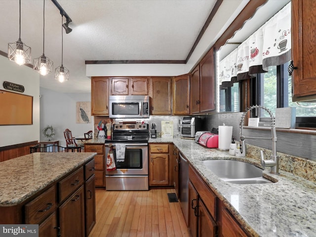 11815 Oriole Dr, Hagerstown, MD 21742 - kitchen featuring stainless steel appliances, a sink, light wood finished floors, and light stone counters