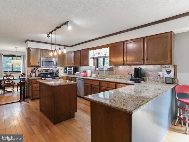 11815 Oriole Dr, Hagerstown, MD 21742 - kitchen featuring stainless steel appliances, a sink, a textured ceiling, rail lighting, and a peninsula