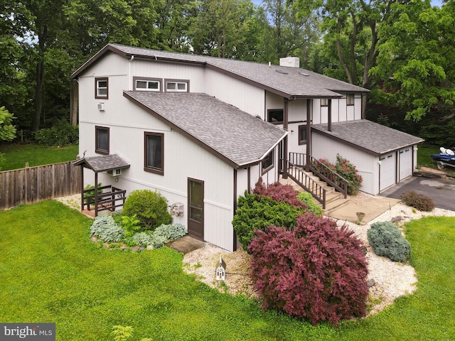11815 Oriole Dr, Hagerstown, MD 21742 - view of front facade with roof with shingles, a garage, a chimney, and view of scattered trees