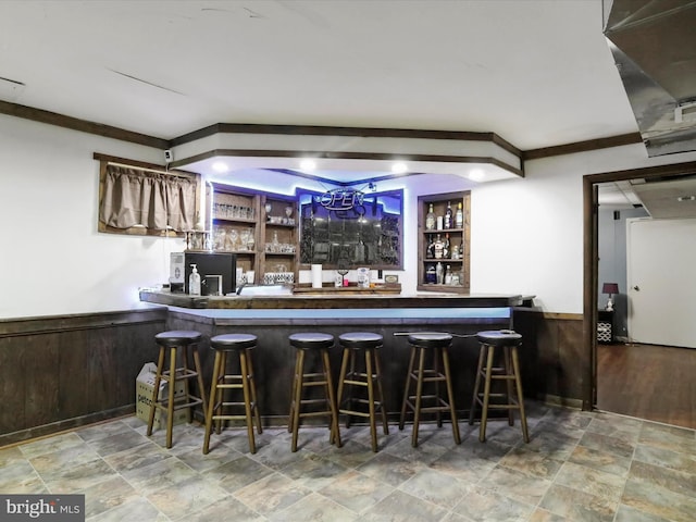 11815 Oriole Dr, Hagerstown, MD 21742 - indoor wet bar featuring a wainscoted wall and stone finish floors