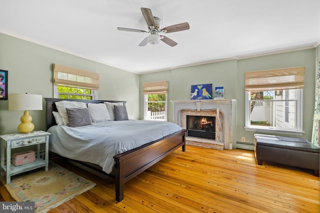 65 Covered Bridge Rd, New Hope, PA 18938 - bedroom with ornamental molding, hardwood / wood-style floors, a fireplace, a ceiling fan, and baseboard heating