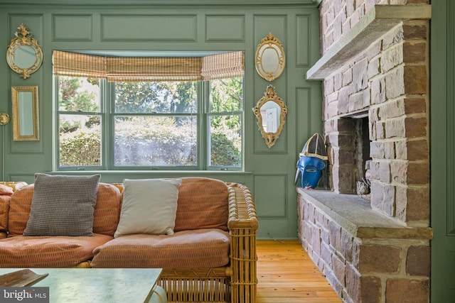 65 Covered Bridge Rd, New Hope, PA 18938 - living room with light wood-style floors, a stone fireplace, and a decorative wall