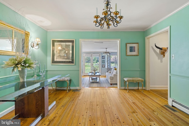 65 Covered Bridge Rd, New Hope, PA 18938 - entryway with a chandelier, a baseboard radiator, hardwood / wood-style floors, baseboards, and crown molding