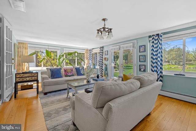 65 Covered Bridge Rd, New Hope, PA 18938 - living area with a chandelier, hardwood / wood-style floors, baseboard heating, and french doors