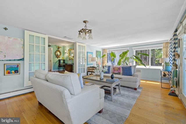65 Covered Bridge Rd, New Hope, PA 18938 - living room featuring hardwood / wood-style floors, a chandelier, and a baseboard radiator