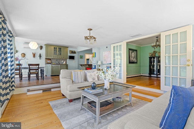 65 Covered Bridge Rd, New Hope, PA 18938 - living room featuring a chandelier, light wood finished floors, and a baseboard radiator