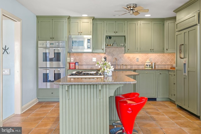 65 Covered Bridge Rd, New Hope, PA 18938 - kitchen featuring green cabinets, built in appliances, light tile patterned flooring, tasteful backsplash, and recessed lighting