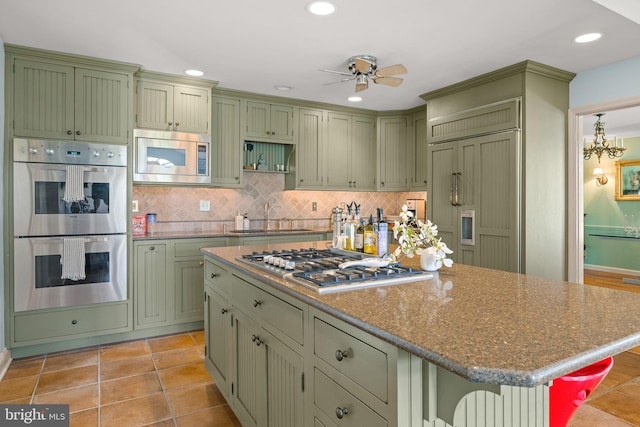 65 Covered Bridge Rd, New Hope, PA 18938 - kitchen with green cabinets, built in appliances, ceiling fan, tasteful backsplash, and a sink