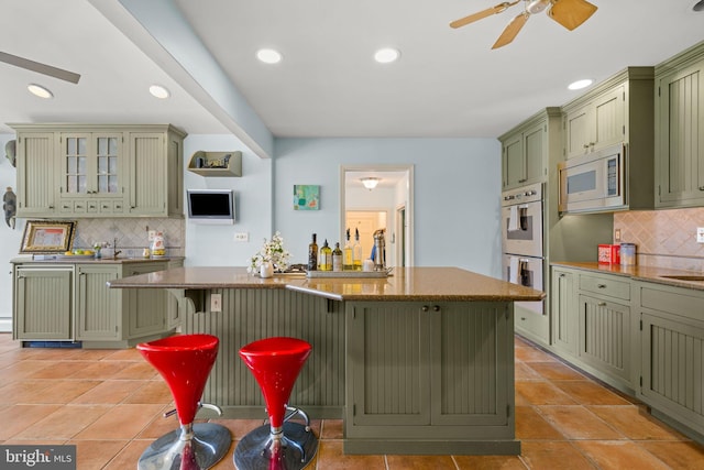 65 Covered Bridge Rd, New Hope, PA 18938 - kitchen featuring green cabinetry, decorative backsplash, double oven, ceiling fan, and recessed lighting