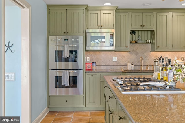 65 Covered Bridge Rd, New Hope, PA 18938 - kitchen with green cabinetry, appliances with stainless steel finishes, a sink, and tasteful backsplash