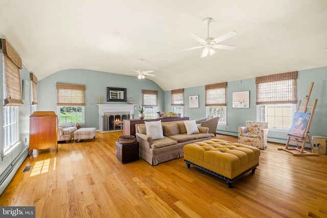 65 Covered Bridge Rd, New Hope, PA 18938 - living area with a baseboard radiator, ceiling fan, light wood-style flooring, healthy amount of natural light, and lofted ceiling