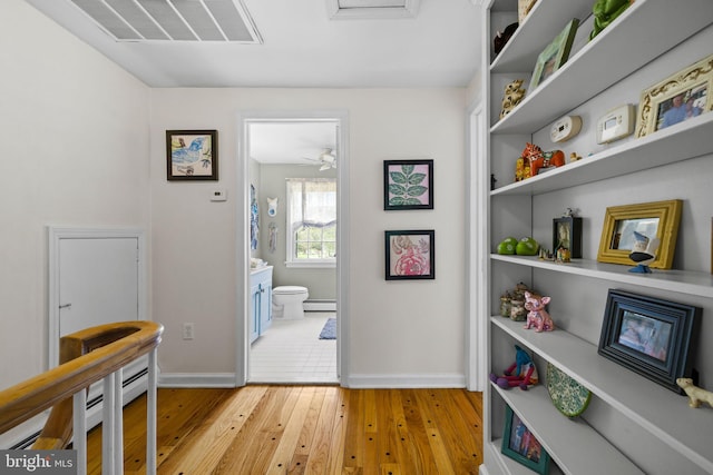65 Covered Bridge Rd, New Hope, PA 18938 - hallway featuring light wood finished floors, baseboards, and a baseboard radiator