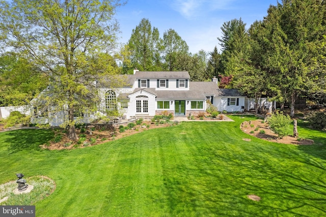 65 Covered Bridge Rd, New Hope, PA 18938 - view of front facade with french doors, a chimney, stone siding, and a front yard