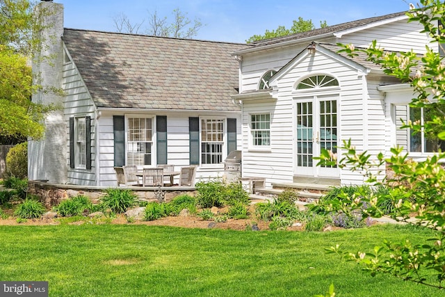 65 Covered Bridge Rd, New Hope, PA 18938 - back of property with french doors, a chimney, and a lawn