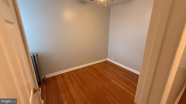 2126 E Sanger St, Philadelphia, PA 19124 - empty room featuring dark wood-style flooring, radiator, and a ceiling fan