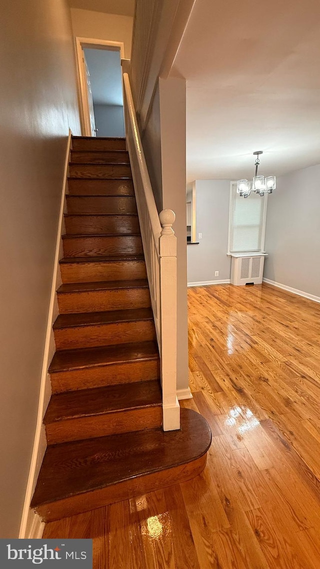 2126 E Sanger St, Philadelphia, PA 19124 - stairs featuring a chandelier and wood finished floors