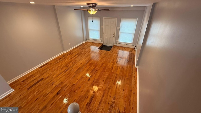2126 E Sanger St, Philadelphia, PA 19124 - doorway to outside with a baseboard heating unit, a ceiling fan, and wood finished floors