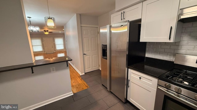 2126 E Sanger St, Philadelphia, PA 19124 - kitchen with stainless steel appliances, white cabinetry, ceiling fan, decorative backsplash, and pendant lighting