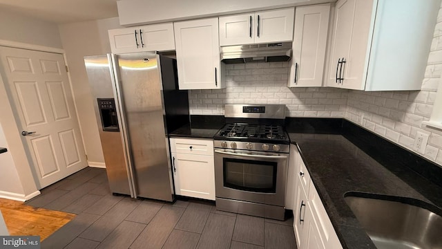 2126 E Sanger St, Philadelphia, PA 19124 - kitchen featuring stainless steel appliances, under cabinet range hood, white cabinets, and decorative backsplash