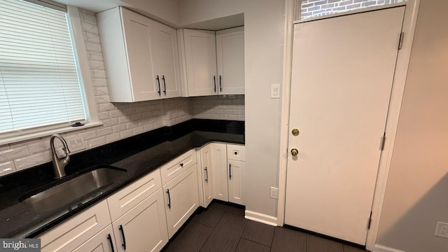 2126 E Sanger St, Philadelphia, PA 19124 - kitchen with backsplash, white cabinetry, and dark stone counters