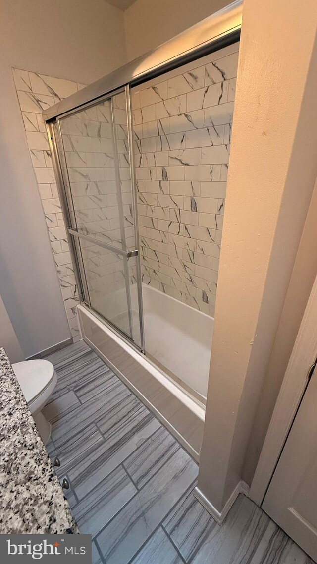 2126 E Sanger St, Philadelphia, PA 19124 - bathroom featuring bath / shower combo with glass door and toilet
