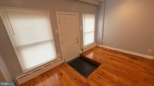2126 E Sanger St, Philadelphia, PA 19124 - foyer entrance featuring a baseboard heating unit, baseboard heating, and wood finished floors