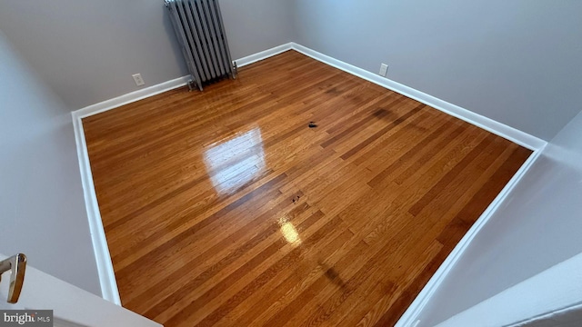 2126 E Sanger St, Philadelphia, PA 19124 - empty room with wood finished floors and radiator