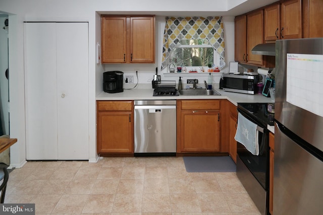 9 Wyndham Ct, Downingtown, PA 19335 - kitchen featuring stainless steel appliances, a sink, light countertops, and brown cabinets