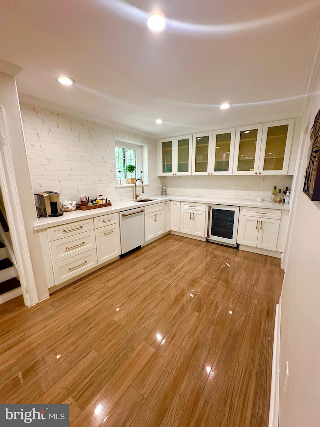 1319 Remington Rd, Wynnewood, PA 19096 - kitchen with dishwasher, wine cooler, white cabinetry, glass insert cabinets, and backsplash