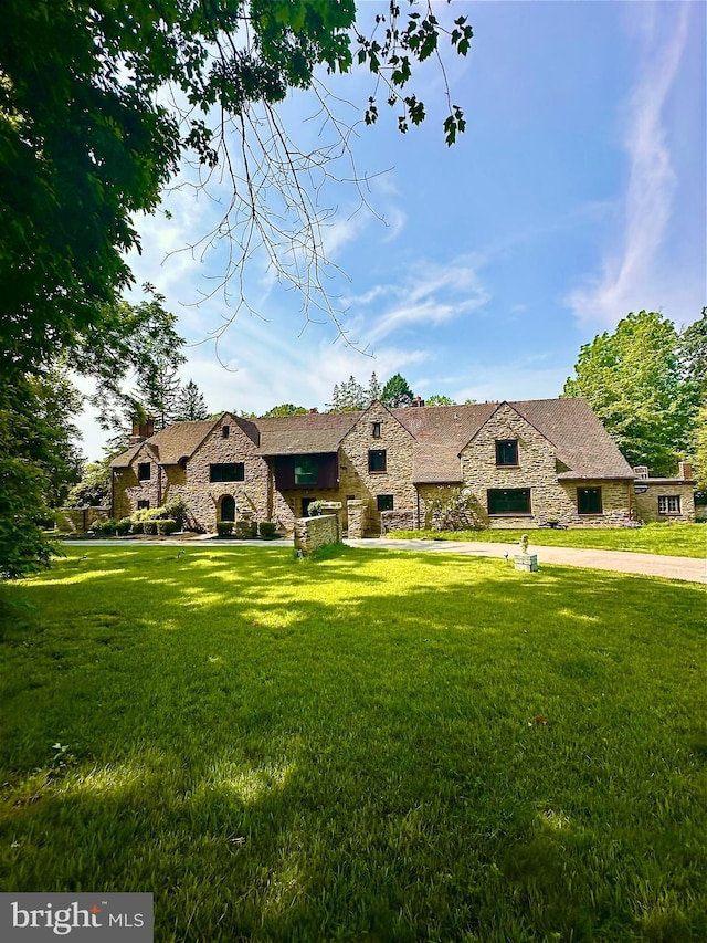 1319 Remington Rd, Wynnewood, PA 19096 - french country style house with stone siding and a front lawn