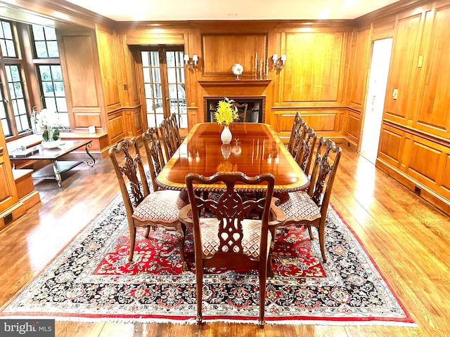1319 Remington Rd, Wynnewood, PA 19096 - dining room with light wood finished floors, crown molding, a decorative wall, and a fireplace