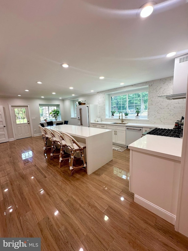 1319 Remington Rd, Wynnewood, PA 19096 - kitchen featuring dishwasher, a sink, recessed lighting, white cabinets, and extractor fan