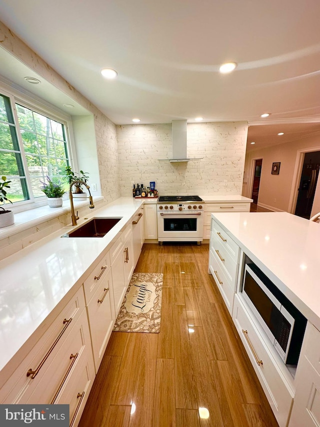 1319 Remington Rd, Wynnewood, PA 19096 - kitchen featuring high end white range, a sink, wall chimney range hood, light countertops, and stainless steel microwave