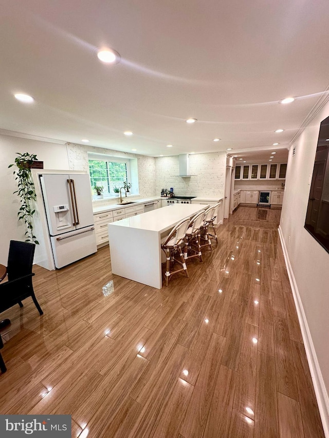 1319 Remington Rd, Wynnewood, PA 19096 - kitchen featuring white fridge with ice dispenser, light countertops, a sink, recessed lighting, and a kitchen island