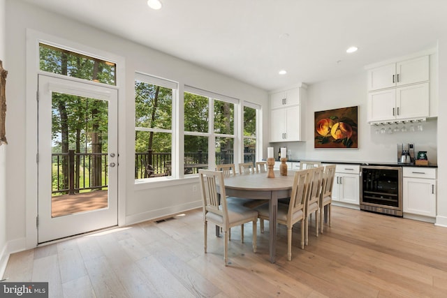 3546 Sutton Heights Cir, Fairfax, VA 22031 - dining space with beverage cooler, healthy amount of natural light, recessed lighting, a bar, and light wood-style floors