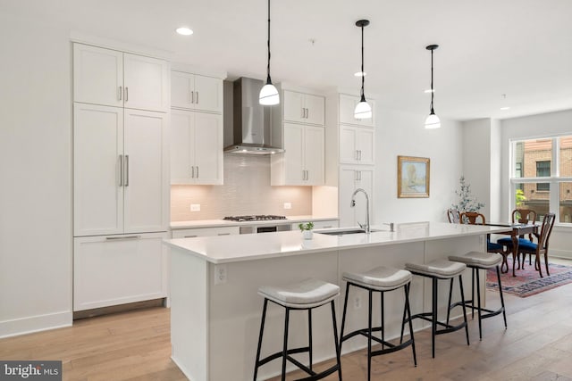 3546 Sutton Heights Cir, Fairfax, VA 22031 - kitchen with wall chimney range hood, light wood finished floors, decorative backsplash, paneled refrigerator, and recessed lighting