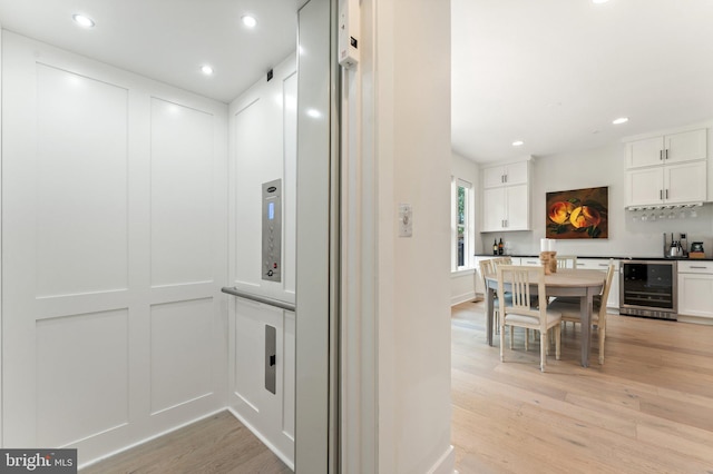 3546 Sutton Heights Cir, Fairfax, VA 22031 - corridor with beverage cooler, elevator, light wood-style floors, and recessed lighting