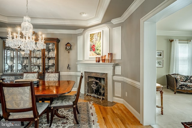 1217 Tullamore Cir, Chester Springs, PA 19425 - dining space featuring wood finished floors, a chandelier, ornamental molding, and a fireplace