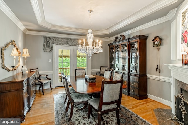 1217 Tullamore Cir, Chester Springs, PA 19425 - dining room with light wood-style flooring, a chandelier, crown molding, a raised ceiling, and a high end fireplace